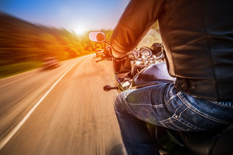 Clear sunny day out for a motorcycle ride wearing jeans and leather jacket