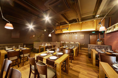 Restaurant dining area finished in natural wood tones