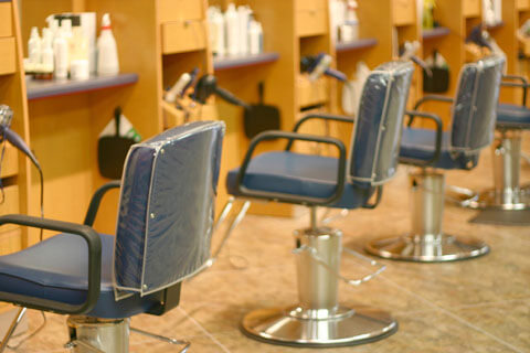 Barber stations in a line inside a modern hair salon